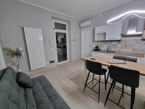 a living room with a couch and a table and chairs at Cà Fiamma 1 in Casale Monferrato
