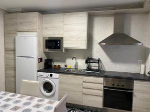 a kitchen with a white refrigerator and a dishwasher at TRES COLUMNAS in Ciudad-Rodrigo
