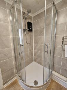 a shower with a glass enclosure in a bathroom at Pet Friendly 2 Bed Coastal Property - Millendreath, Looe in Looe