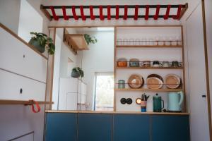 a kitchen with blue cabinets and a red awning at Kleinstes Haus Deutschlands in Bremen