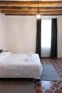 a bedroom with a bed and a large window at Traditional Italian House - Bergamo in Bergamo