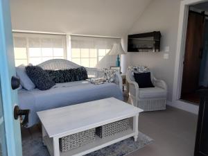 a living room with a couch and a chair at Sandtrap Cape Cod in West Yarmouth