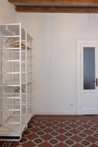 a white book shelf in a room with a door at Traditional Italian House - Bergamo in Bergamo