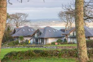 a group of houses with a view of the ocean at The Paddock, Castle Approach, Tregenna Castle, St Ives in St Ives