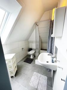 a bathroom with a sink and a toilet at Haus Storjohann in Dagebüll