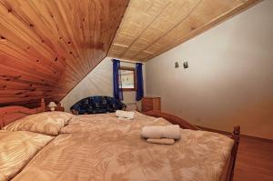 a bedroom with a large bed with two towels on it at Apartmany pod Tatrami in Važec