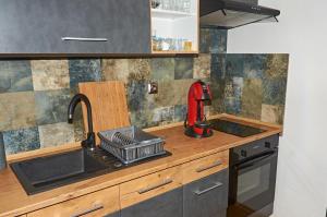 a kitchen with a sink and a counter top at Apartmany pod Tatrami in Važec