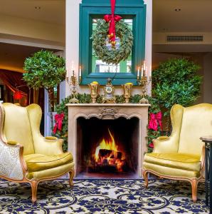 a living room with a fireplace and a christmas wreath at Stikliai Hotel - Relais & Châteaux in Vilnius