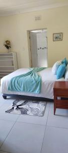 a bedroom with a bed and a table and a mirror at Khanyisa Accommodation Services in KwaDukuza