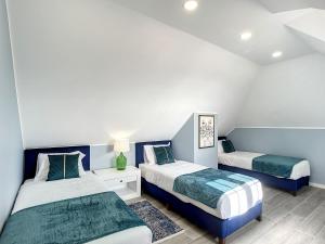 two beds in a room with blue and white at Casa da Horta by Atlantic Holiday in Santa Cruz