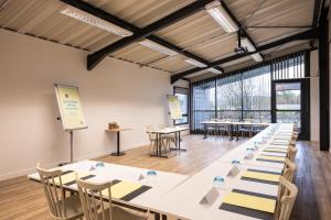 a large room with tables and chairs in it at Greet hotel Bourg-en-Bresse Sud Montagnat in Montagnat