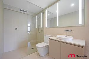 a bathroom with a toilet and a sink and a shower at MetaWise Sydney CBD Haymarket Luxe 2Bed Penthouse Aqua in Sydney +19 photos