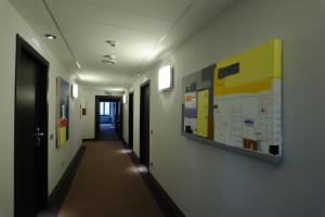 a hallway in an office with a poster on the wall at Park Hotel Sporting in Teramo