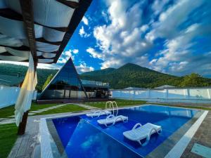 a resort with a pool and a building at Qafqaz Royal Chalet in Gabala