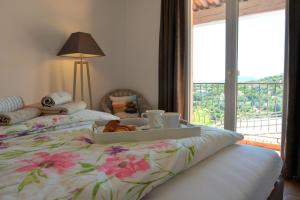 a bedroom with a bed with a tray on it at Provenzalisches Haus La Grenouille - Terrasse mit Meerblick und privatem Pool by Riviera HomeLife in Les Issambres