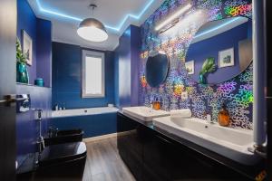 a blue bathroom with two sinks and a mirror at Luxury Home Affair in Oradea