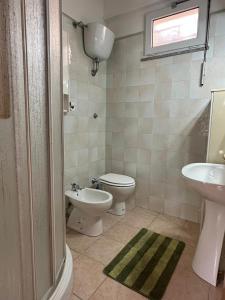 uma casa de banho com um WC, um bidé e um lavatório. em Nel cuore della città em La Maddalena