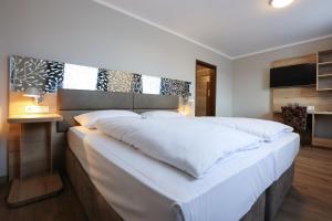 Postel nebo postele na pokoji v ubytování Arthotel ANA Flair