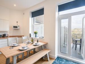 a kitchen and dining room with a table and a window at Apartment 5 Victoria House in Lyme Regis