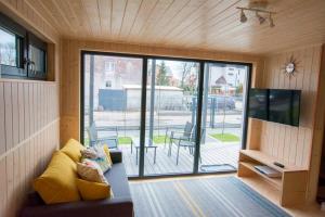 a living room with a large sliding glass door at Domki KREDKA in Jastarnia