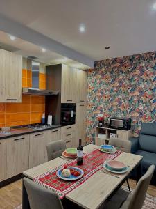 a kitchen with a table with plates on it at Casa Patrizia elegante dimora con biliardino in Battipaglia