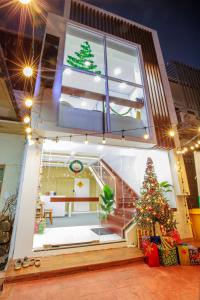 a house with a christmas tree inside of it at Lafami Hostel in Ban Nongdouang