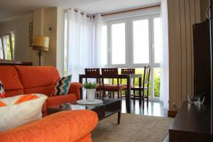 a living room with a couch and a table at EL COLLADO, Ruiloba in Sierra