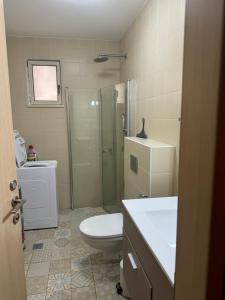 a bathroom with a toilet and a shower and a sink at Cottage in Center of Historic Zichron Yaakov in Zikhron Ya‘aqov