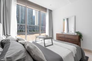 a bedroom with a large bed and a large window at Premium Downtown apartment 2BD, 5 MIN DUBAI MALL in Dubai