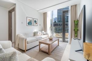 a living room with a couch and a table at Premium Downtown apartment 2BD, 5 MIN DUBAI MALL in Dubai