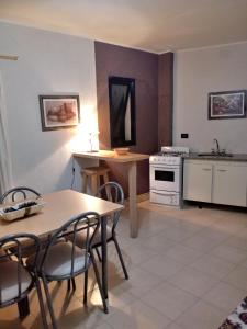 a kitchen with a table and chairs and a television at Chalet Arena Malva in San Bernardo