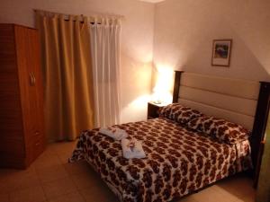 a hotel room with a bed with a tray on it at Chalet Arena Malva in San Bernardo