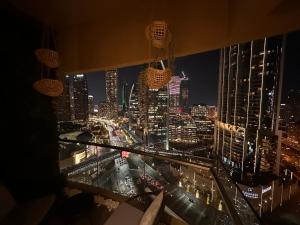 a view of a city skyline at night at Deluxe - Address Dubai Mall - The Residence in Dubai