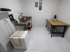 a small kitchen with a table and a counter at KitNet Confort Garanhuns (101) in Garanhuns +9 photos