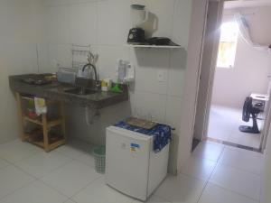 a kitchen with a sink and a small refrigerator at Kitnet Aconchegante próx. ao centro da Cidade(102) in Garanhuns