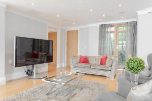 a living room with a large flat screen tv at Stunning 5BR 4BA Mansion - Hendon in Hendon