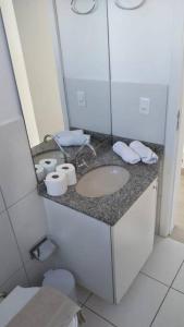 a bathroom with a sink and a mirror at Apartamento Juvevê. in Curitiba