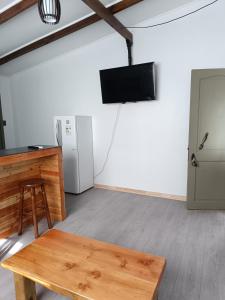 a room with a table and a television and a refrigerator at Punto clave in Pudeto