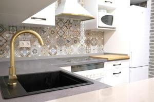 a kitchen with a sink and a faucet at Seaview Heaven - Otium Apartments in Santa Pola