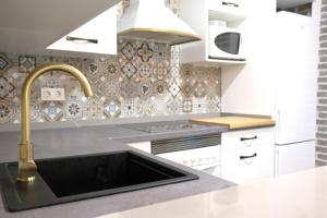 a kitchen with a sink and a faucet at Seaview Heaven - Playa a 100m in Santa Pola +23 photos