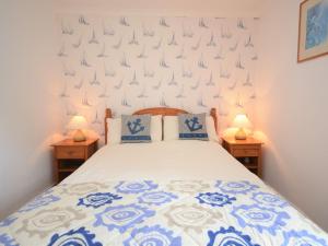 1 dormitorio con 1 cama con sábanas azules y blancas en 1 Bed in Cardigan MOOST, en Saint Dogmaels