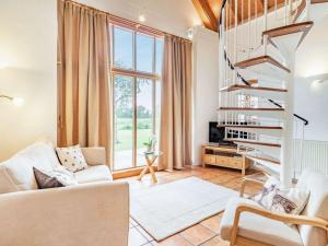 a living room with a couch and a spiral staircase at 2 Bed in Bury St Edmunds OXBAR in Market Weston