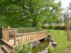 a wooden bridge over a river with a bench on it at 1 Bed in Bude WSCOT in Pancrasweek