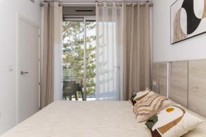 a bedroom with a bed and a large window at Espanatour VALERIA in Torrevieja