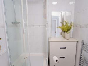 a white bathroom with a shower and a mirror at 2 Bed in Ryde 91982 in Brading
