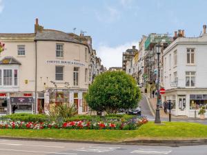 a city street with buildings and flowers on the street at 2 Bed in Ryde 91982 in Brading