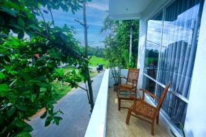 two chairs sitting on the porch of a house at Villa Greenline in Ahangama