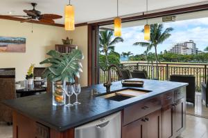 a kitchen with a counter with a view of the ocean at Ko Olina Beach Villas O414 in Kapolei