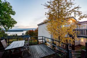 a wooden deck with a table and chairs on it at Studio apartment in lake views in Tampere