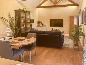 a living room with a couch and a table at Sykelands Cottage in Ravensworth